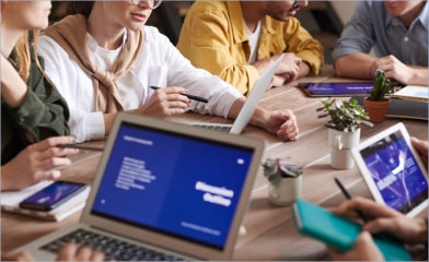 a lot of people with laptop in meeting desk